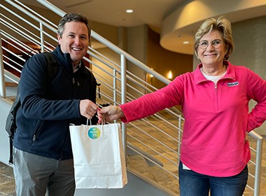 employee receiving a bag of swag