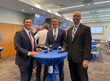 three employees celebrating