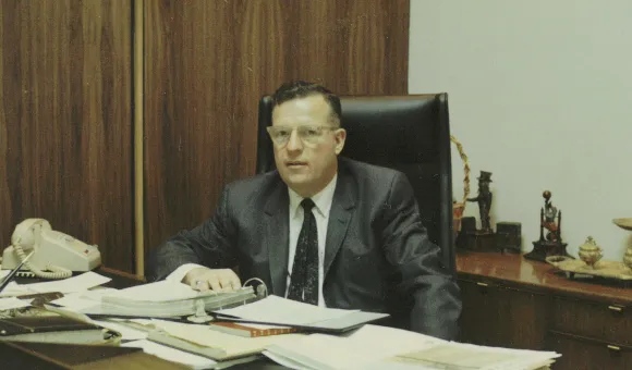 Mickey Landen sitting at desk in 1966