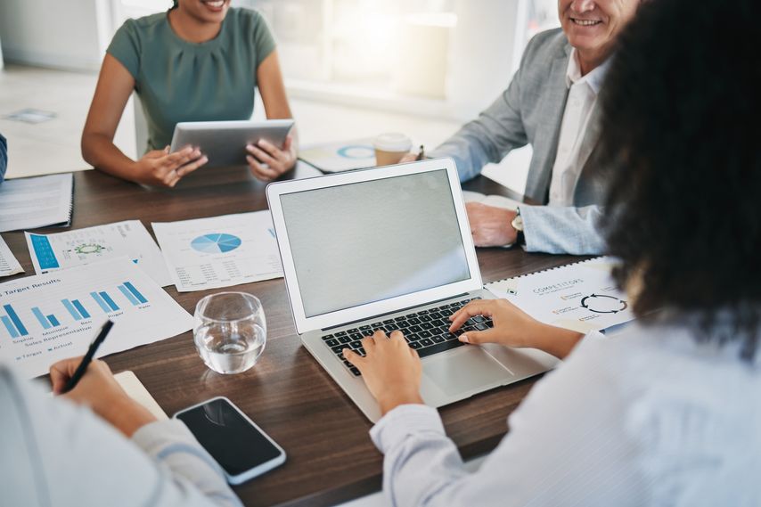 woman at laptop in group setting